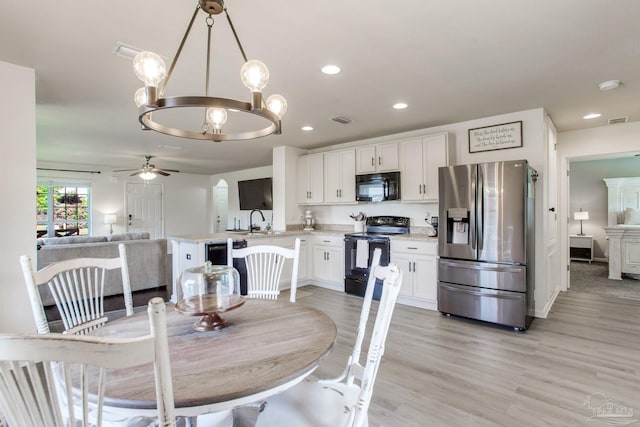 dining room with visible vents, recessed lighting, ceiling fan with notable chandelier, and light wood-type flooring