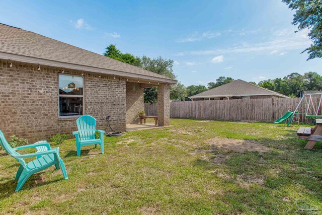 view of yard featuring a fenced backyard and a playground