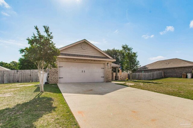 view of front of property with concrete driveway, brick siding, fence, and a front yard