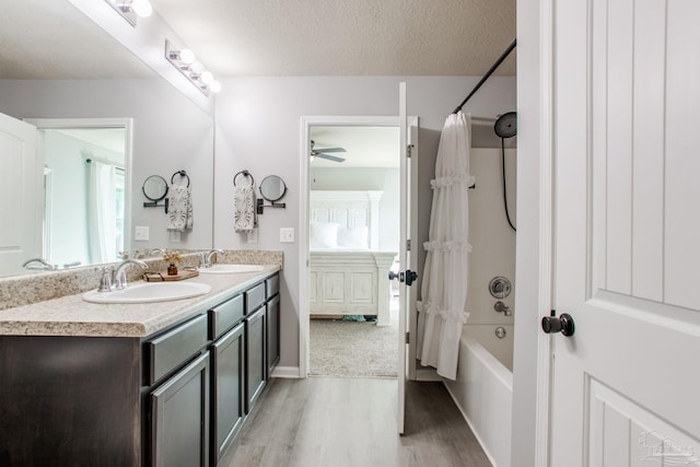 full bathroom featuring a sink, double vanity, wood finished floors, and shower / tub combo with curtain
