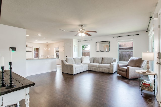 living room featuring visible vents, baseboards, dark wood-style floors, recessed lighting, and ceiling fan with notable chandelier