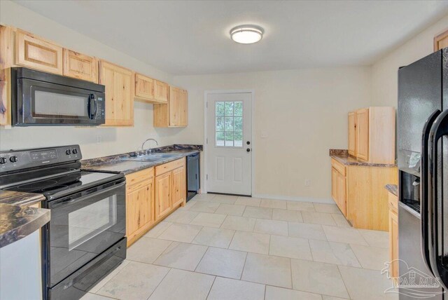4670 Durham Dr, Pensacola, FL 32526 - kitchen featuring black appliances, a sink, light brown cabinets, dark countertops, and baseboards