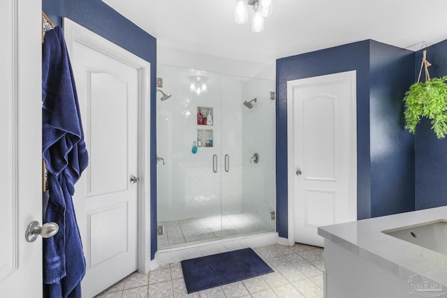 bathroom featuring vanity, tile patterned floors, and a shower with shower door