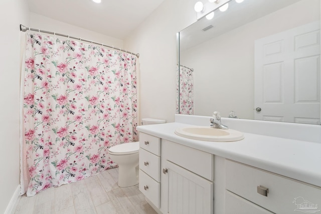 bathroom with visible vents, toilet, curtained shower, and vanity