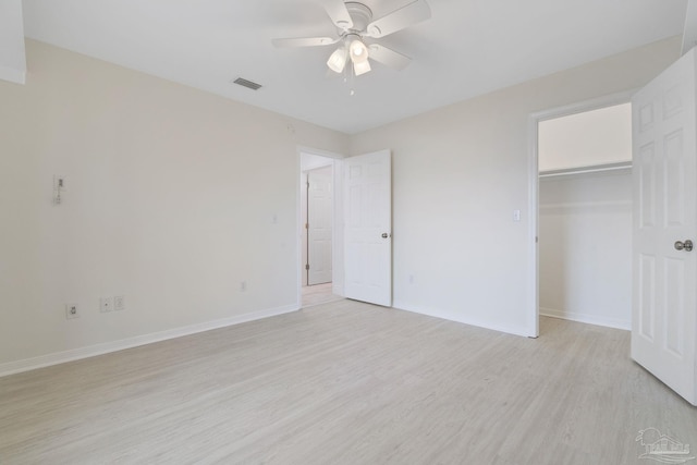 unfurnished bedroom featuring visible vents, a ceiling fan, light wood-type flooring, and baseboards