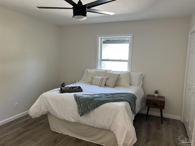 bedroom with dark hardwood / wood-style floors and ceiling fan