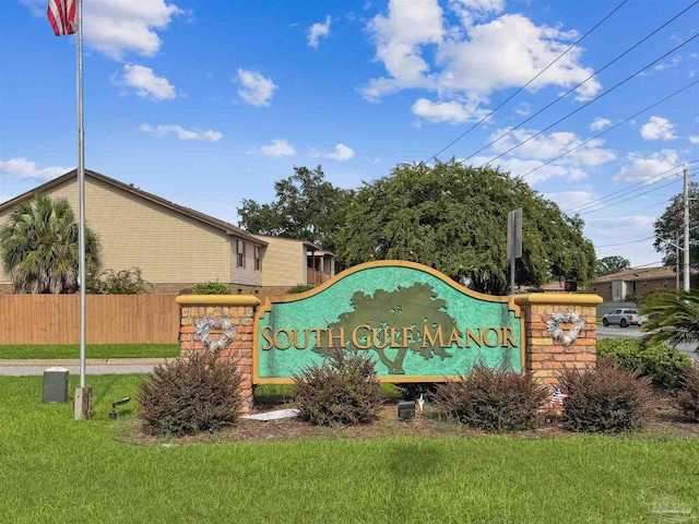 community sign featuring a lawn