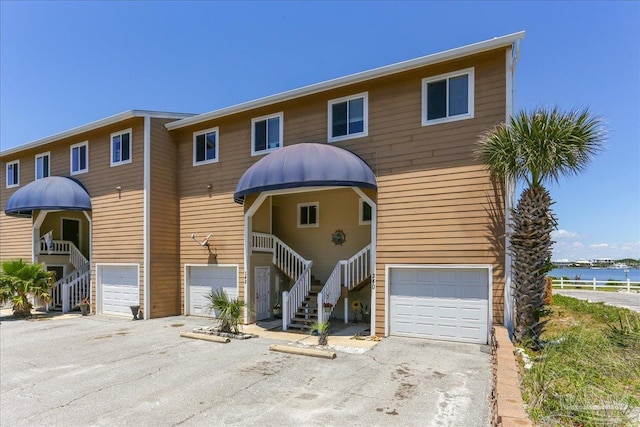 342 Ft Pickens Rd, Pensacola Beach, FL 32561 - view of front facade with an attached garage, stairway, and driveway