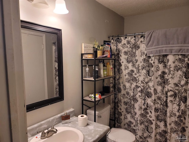 bathroom with a textured ceiling, vanity, toilet, and a shower with curtain