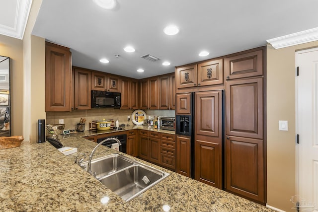 kitchen featuring ornamental molding, a sink, black appliances, and light stone countertops