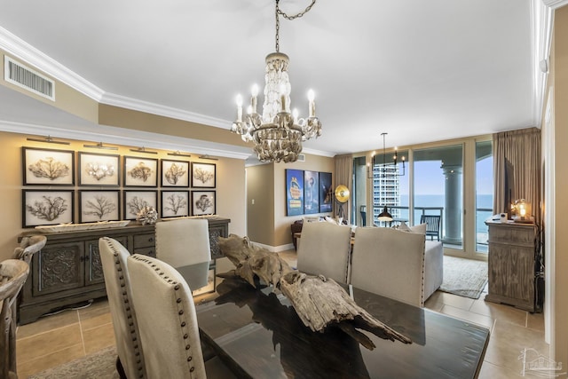 dining space with ornamental molding, a water view, a notable chandelier, and visible vents