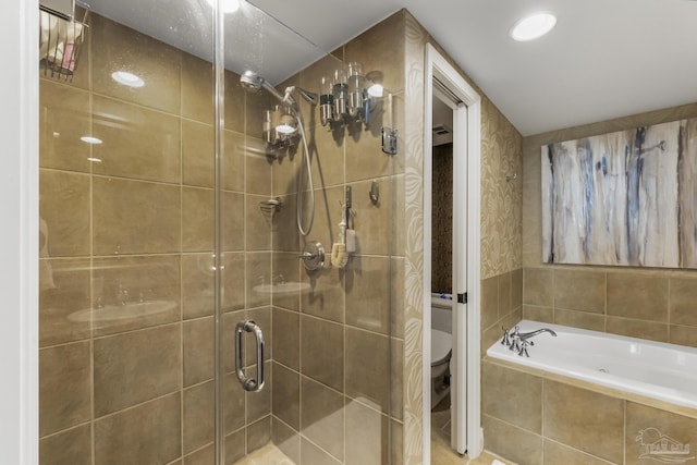 full bathroom with a stall shower, a garden tub, and toilet