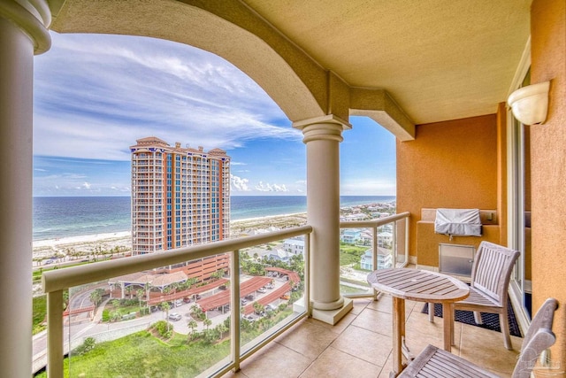 balcony featuring a beach view and a water view