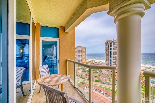 balcony with a water view and a beach view