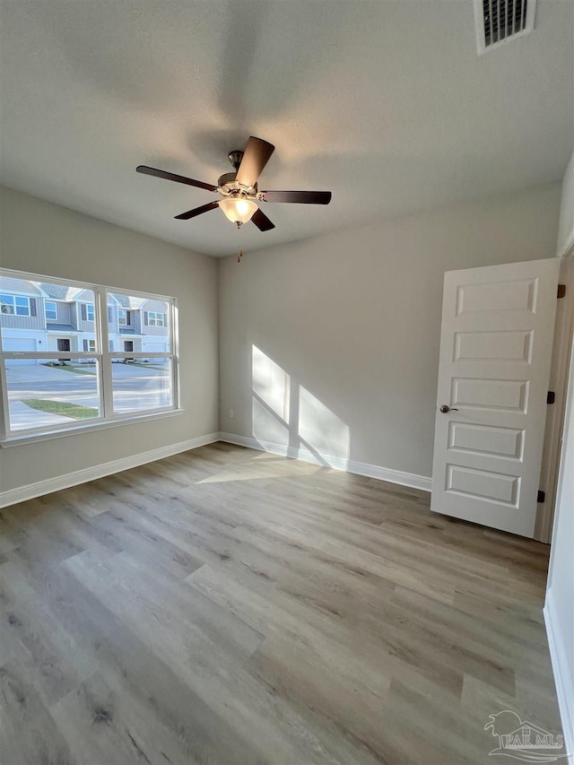 unfurnished room featuring ceiling fan and light wood-type flooring