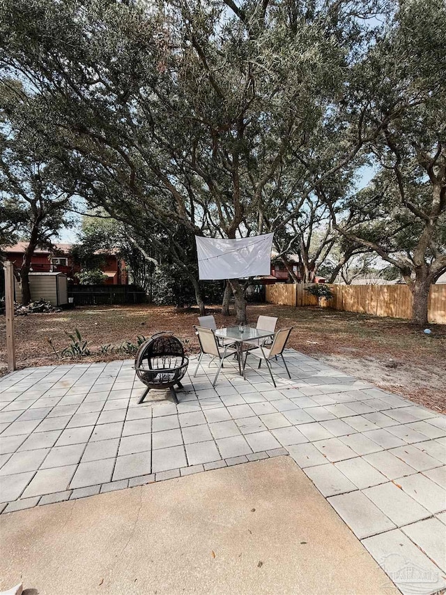 30 Woodham Ave, Ft Walton Beach, FL 32547 - fenced backyard with an outdoor fire pit and a patio area