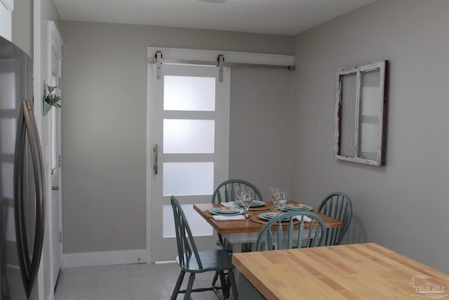 30 Woodham Ave, Ft Walton Beach, FL 32547 - dining room with a barn door and baseboards