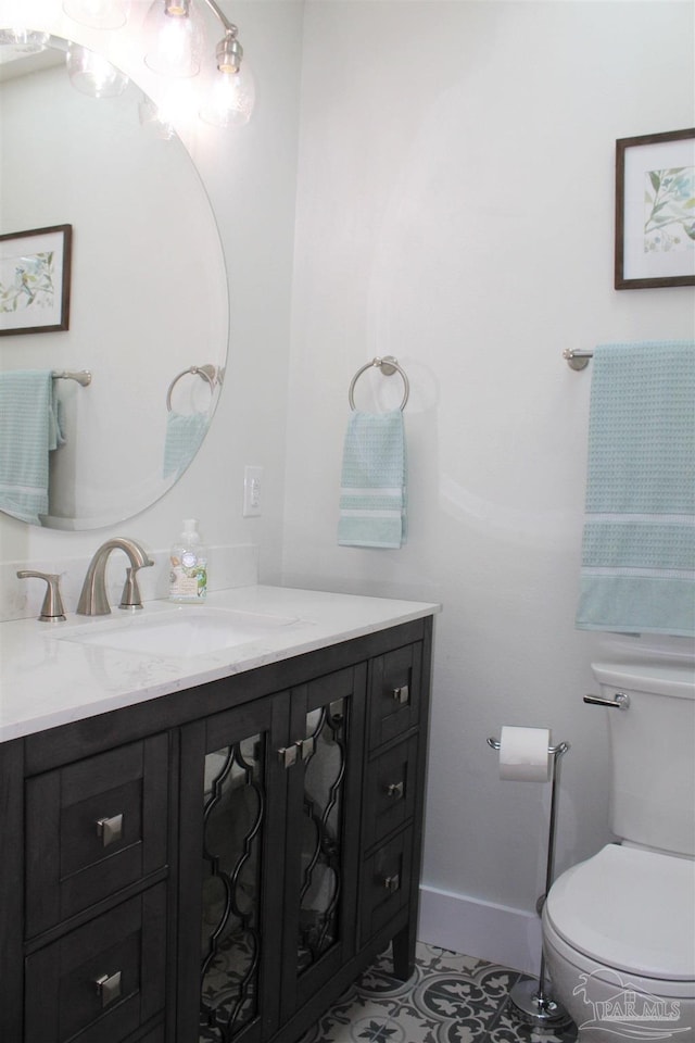 30 Woodham Ave, Ft Walton Beach, FL 32547 - bathroom featuring vanity, toilet, and tile patterned flooring