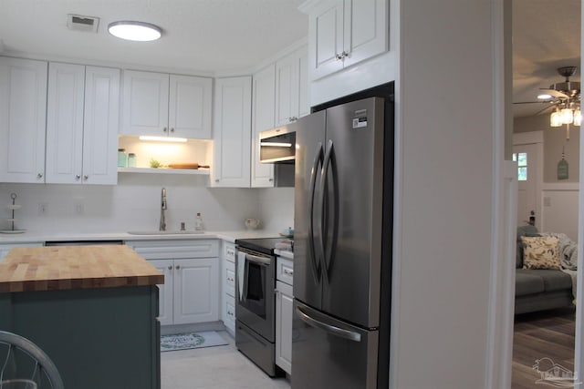 30 Woodham Ave, Ft Walton Beach, FL 32547 - kitchen with butcher block countertops, appliances with stainless steel finishes, a sink, and white cabinets