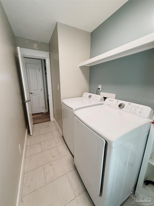 clothes washing area featuring washing machine and dryer