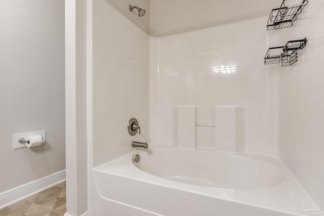 bathroom with tile patterned floors, shower / bath combination, and baseboards