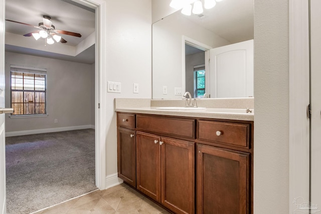 bathroom with tile patterned floors, ceiling fan, vanity, and baseboards