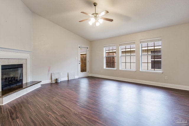 unfurnished living room featuring ceiling fan, a fireplace, dark wood finished floors, lofted ceiling, and baseboards