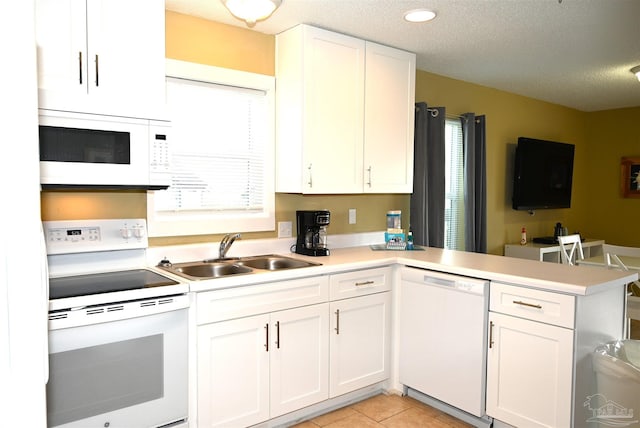 kitchen featuring sink, white cabinetry, plenty of natural light, and white appliances