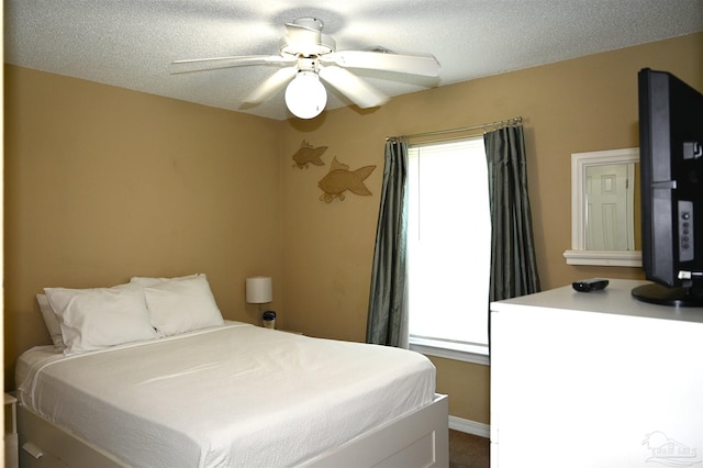 bedroom with a textured ceiling and ceiling fan