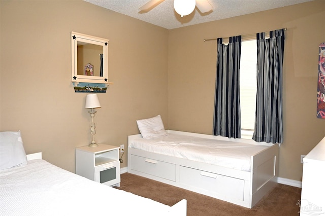 carpeted bedroom with a textured ceiling and ceiling fan