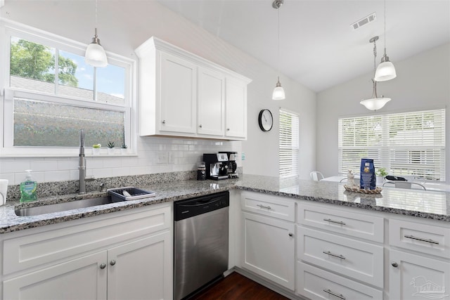 kitchen with plenty of natural light, stainless steel dishwasher, white cabinetry, and lofted ceiling