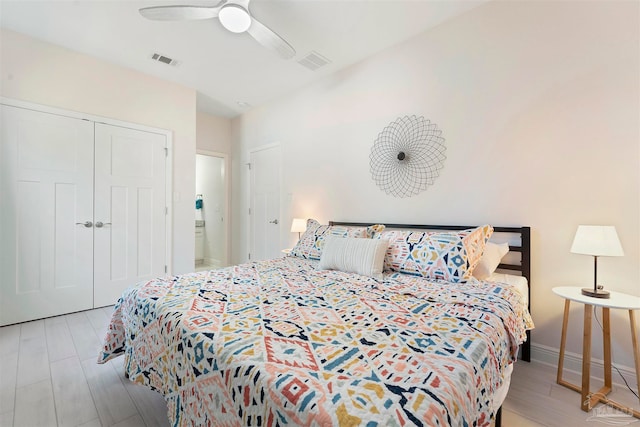 bedroom with light wood-type flooring, a closet, and ceiling fan