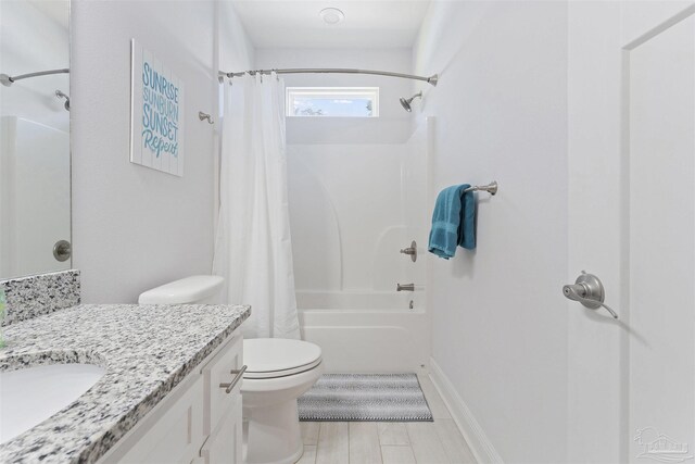 full bathroom with vanity, toilet, and shower / tub combo