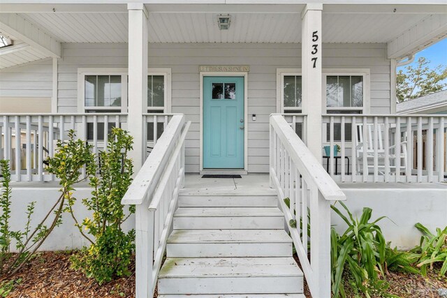 doorway to property featuring covered porch