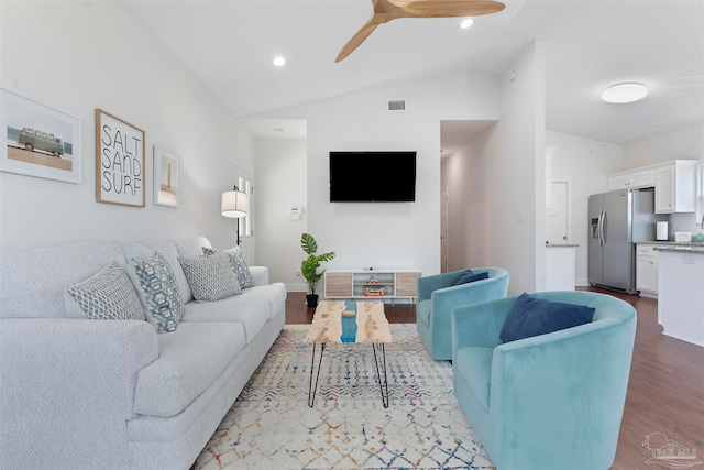 living room with vaulted ceiling, hardwood / wood-style flooring, and ceiling fan