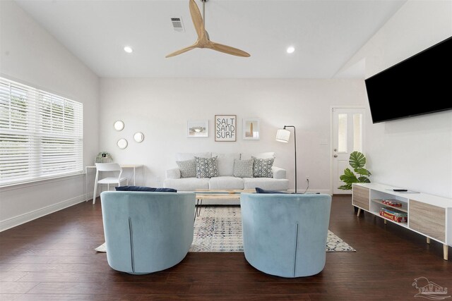 living room featuring dark hardwood / wood-style flooring and vaulted ceiling