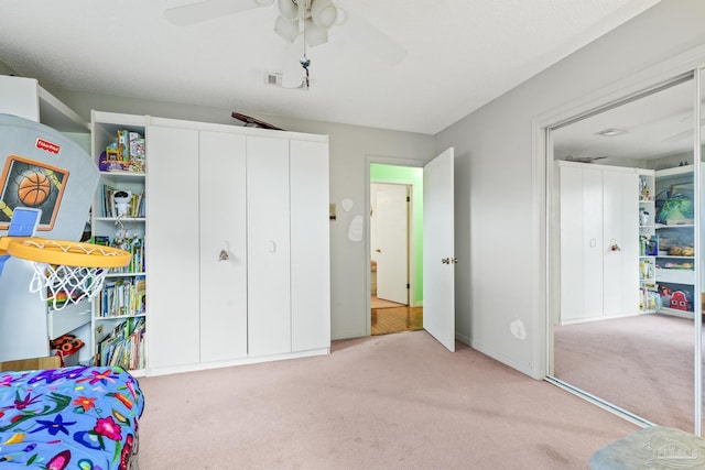 carpeted bedroom featuring a closet and ceiling fan