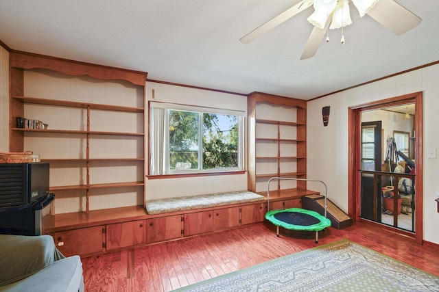 sitting room with crown molding, ceiling fan, and light hardwood / wood-style floors