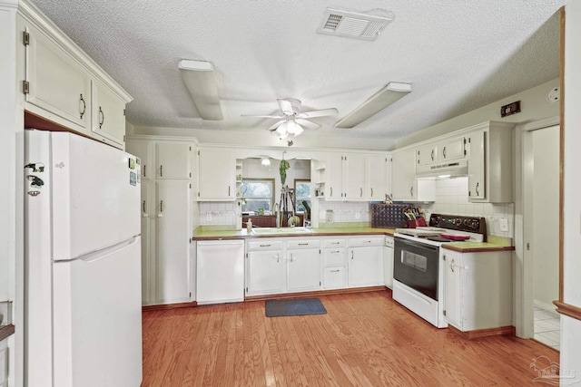kitchen with tasteful backsplash, white appliances, ceiling fan, and light hardwood / wood-style floors