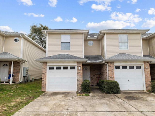 townhome / multi-family property featuring driveway, brick siding, an attached garage, and a shingled roof