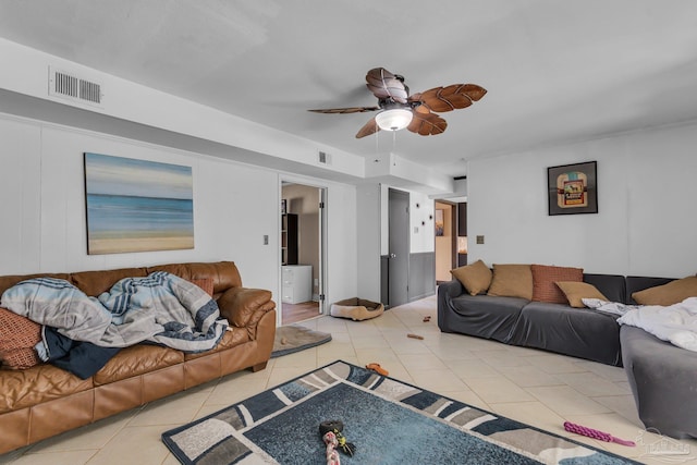 living room featuring light tile patterned floors, a ceiling fan, and visible vents