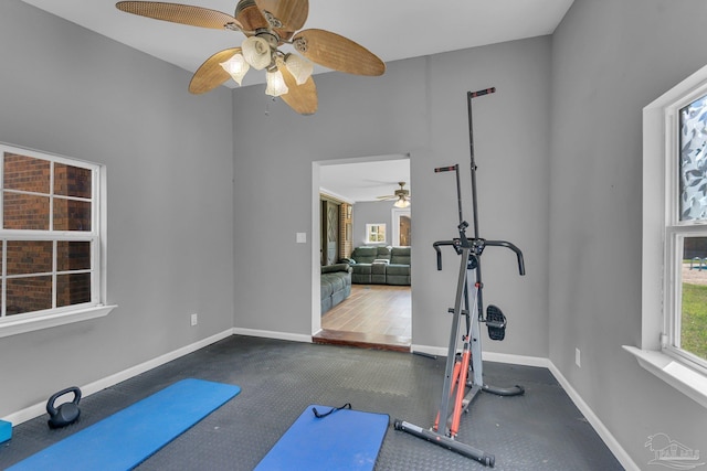 exercise room featuring baseboards and ceiling fan