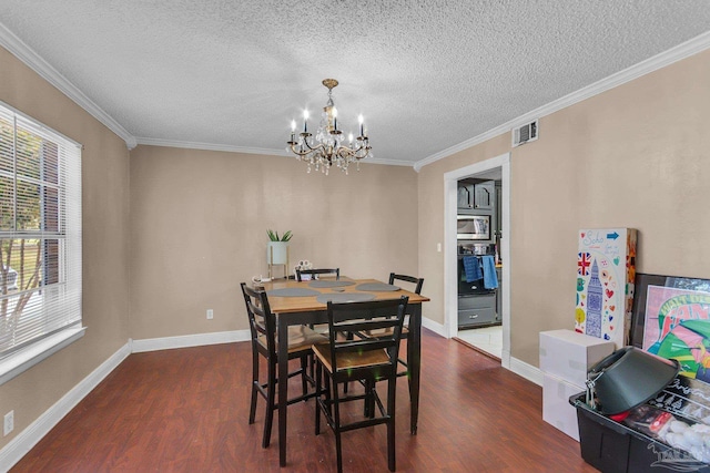 dining area featuring visible vents, an inviting chandelier, dark wood-style floors, and crown molding