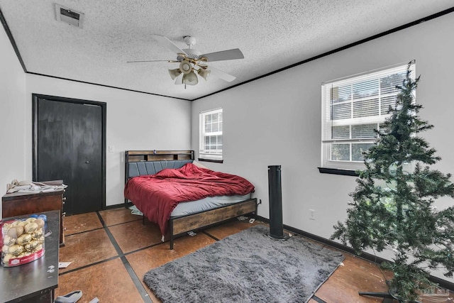 bedroom featuring visible vents, a textured ceiling, crown molding, baseboards, and ceiling fan