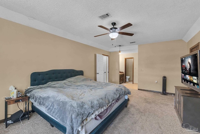 bedroom featuring visible vents, light colored carpet, a textured ceiling, and baseboards