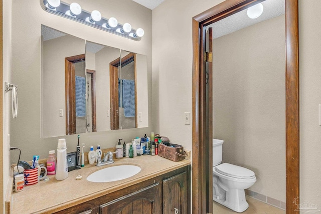 bathroom with tile patterned floors, toilet, and vanity