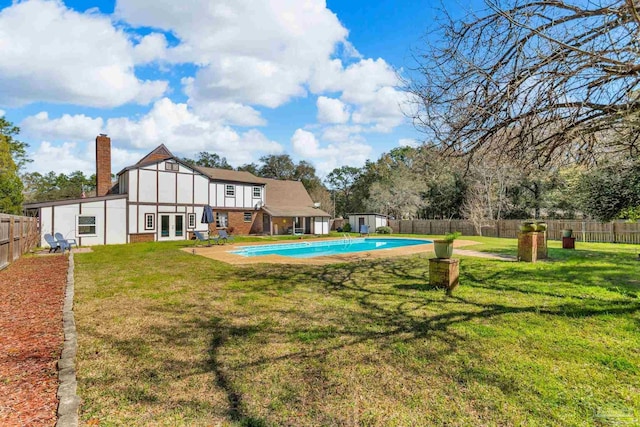 view of yard with french doors, a fenced in pool, and a fenced backyard