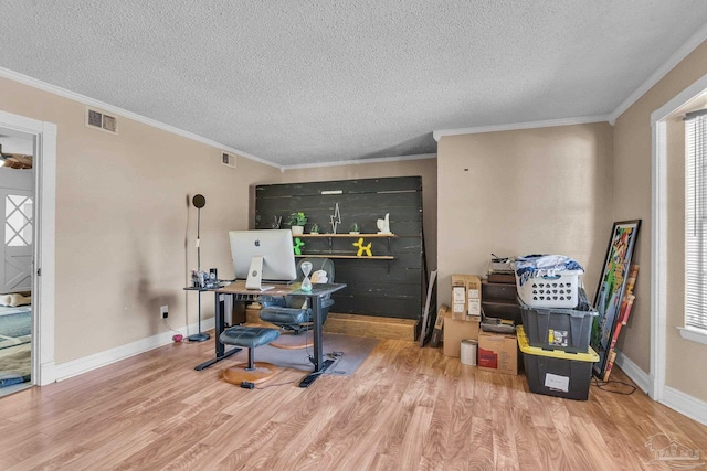 home office featuring visible vents, baseboards, and wood finished floors