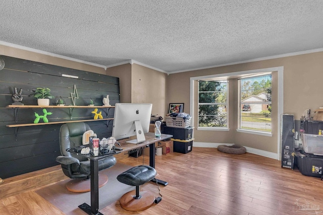 office with hardwood / wood-style floors, a textured ceiling, baseboards, and ornamental molding