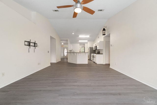 unfurnished living room with lofted ceiling, dark wood-type flooring, and ceiling fan